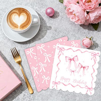 Pink bow cake toppers and balloons for a coquette-themed birthday party