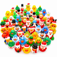 Assorted colorful Christmas rubber ducks arranged together on a white background