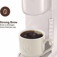 Compact single-serve coffee maker displayed on a kitchen countertop