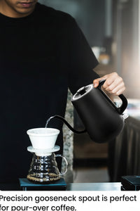 Cordless gooseneck electric kettle placed on its power base
