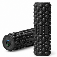 Electric foam roller for back exercises with a textured cylindrical surface.