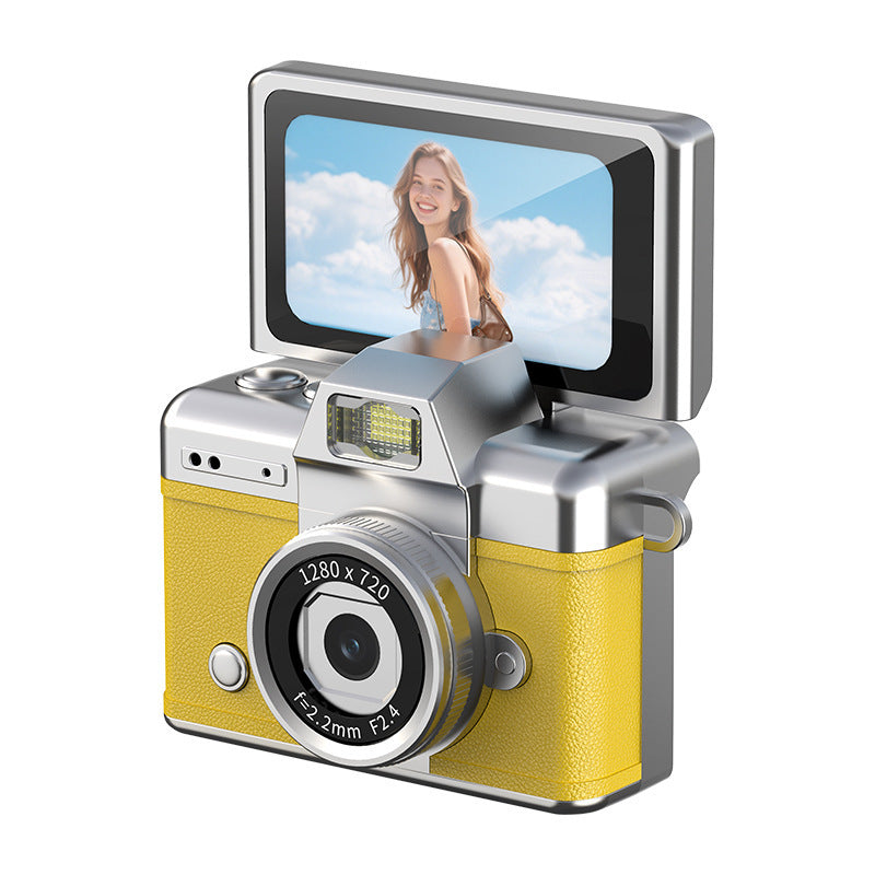 Young adult framing a self-portrait using the raised viewing screen of a compact camera.