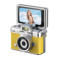 Young adult framing a self-portrait using the raised viewing screen of a compact camera.