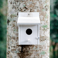 Outdoor wooden bird house for small birds, suitable for garden, patio, and yard use.