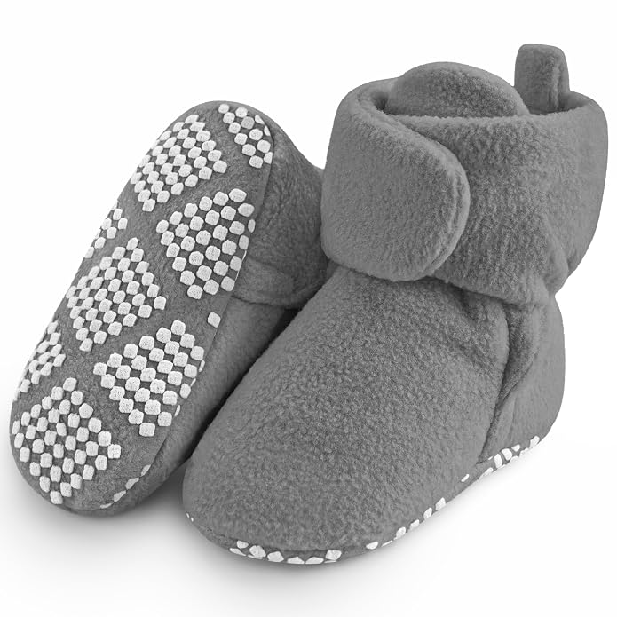 Pair of grey fleece baby booties with white textured grip patterns on the soles.