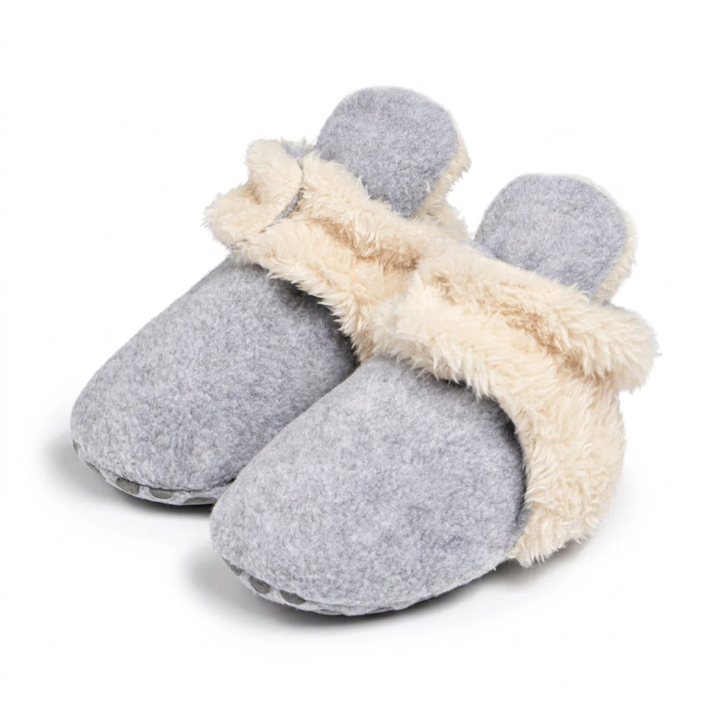Pair of grey baby winter booties with fluffy cream-coloured ankle cuffs on a white background.