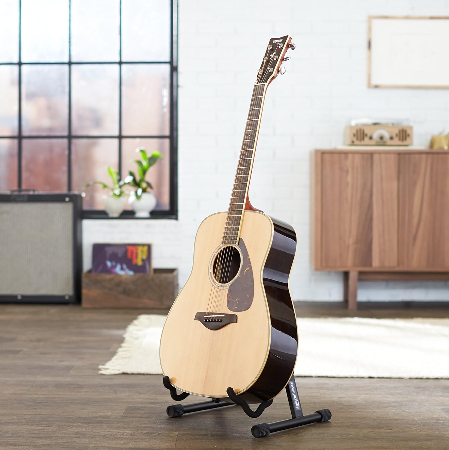 Adjustable guitar stand used in a music studio for acoustic and electric guitars