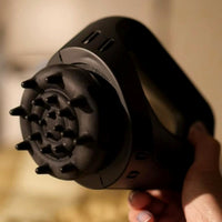Portable massager displayed with a flat wheel attachment