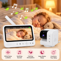 Compact white infant camera with black lens housing and separate monitoring unit