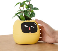 Interactive smart plant companion with animated display and lemon-coloured planter
