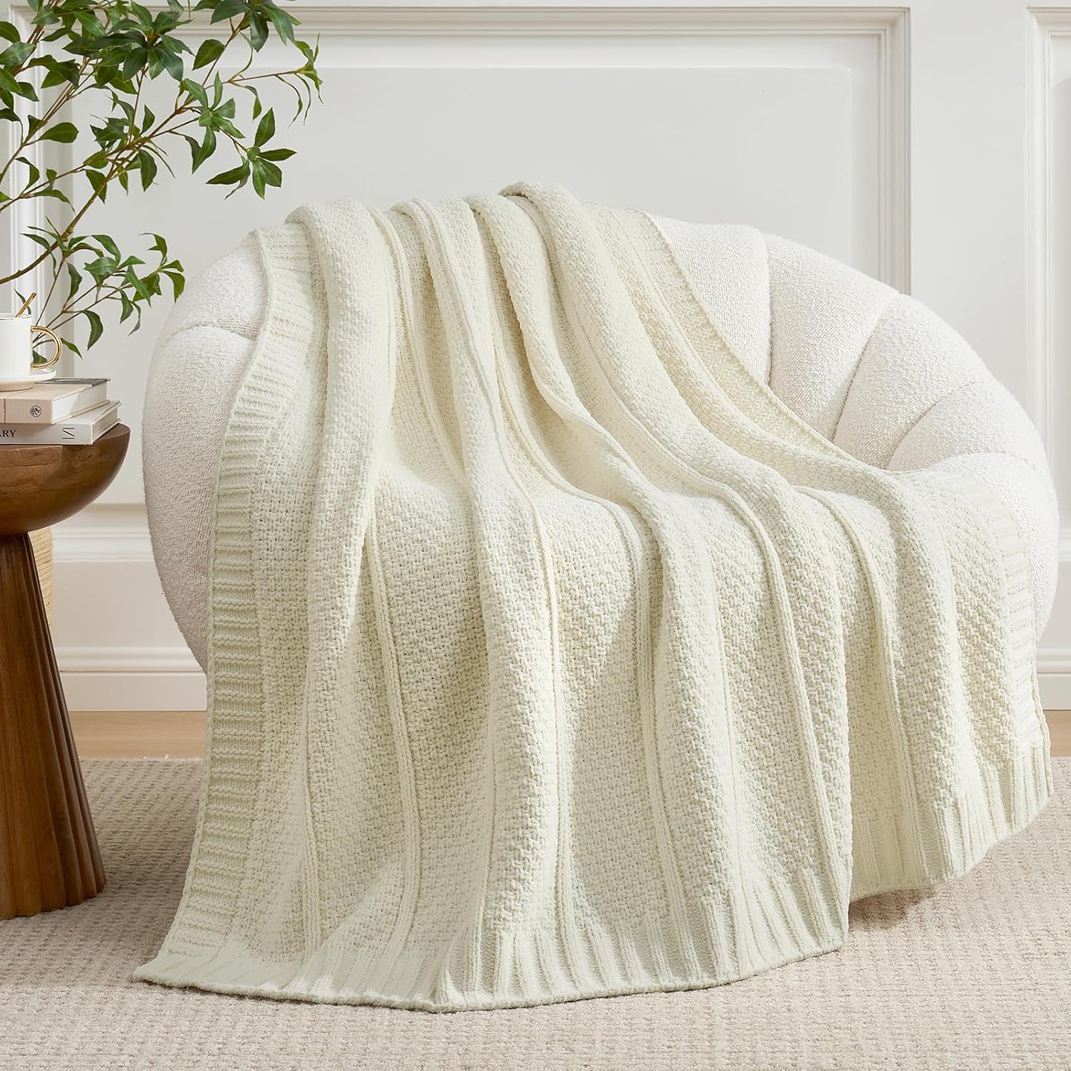 Ivory chenille throw blanket draped over a modern couch