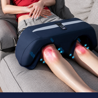 Lower-body massager displayed with charging cable and accessories