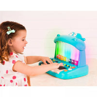Side view of the mini hippo piano toy displaying its shape and keyboard layout.