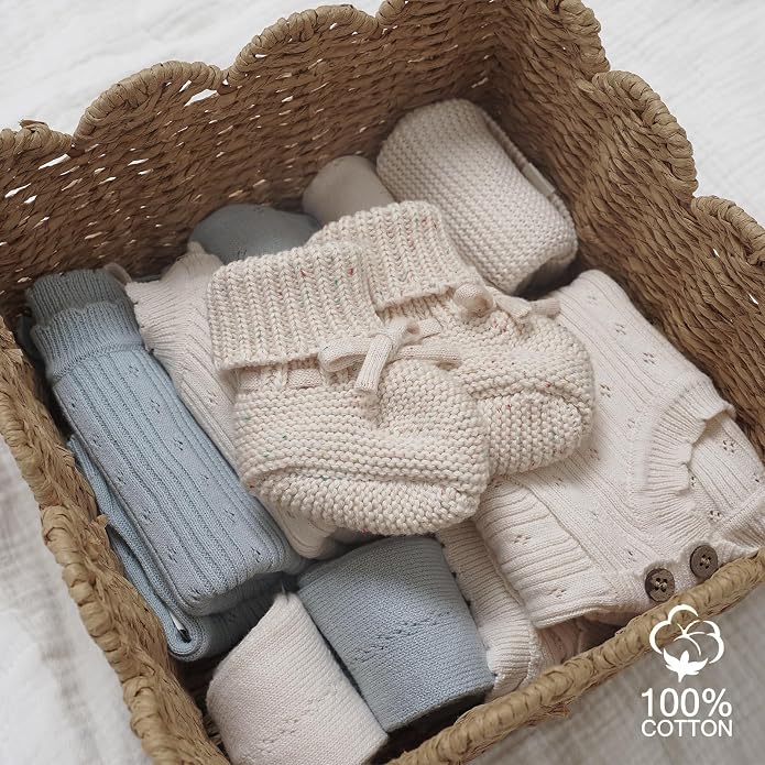 Front view of rounded infant footwear with a cosy fabric exterior.