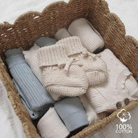 Front view of rounded infant footwear with a cosy fabric exterior.