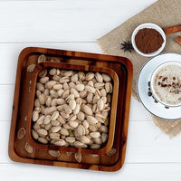 Wooden nut serving bowl displayed on a coffee table