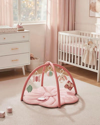 Pink baby play gym with soft padded flower mat