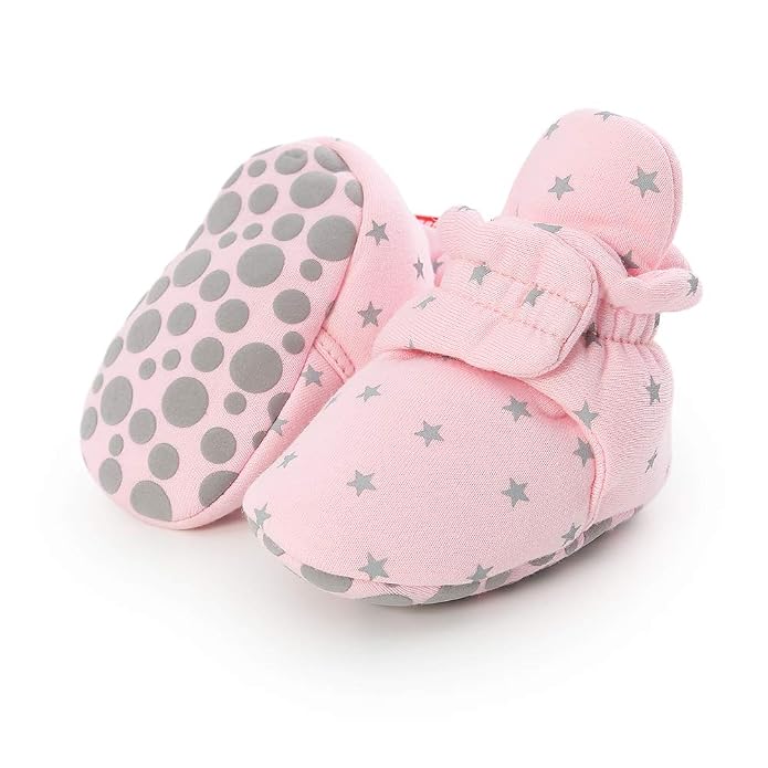 Pair of light pink baby booties featuring grey stars and adjustable ankle straps.