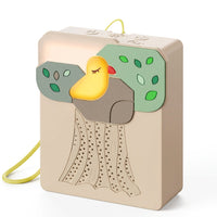 Beige portable baby sound machine with green tree leaves and yellow bird decoration