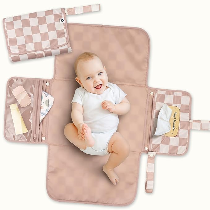 Close up of the smart access wipes pocket on a folded gray diaper clutch