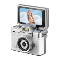 Traveler using a lightweight retro-style camera to photograph a scenic outdoor destination.