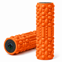 Portable muscle massage device displayed with home workout accessories.