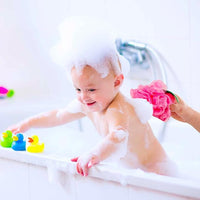 Quick drying mesh bath sponge pouf hanging in bathroom