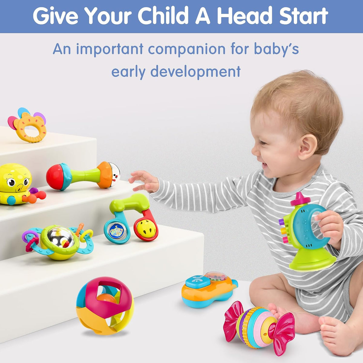 Candy-inspired infant toy with a striped rainbow centre and pink bow-shaped ends.