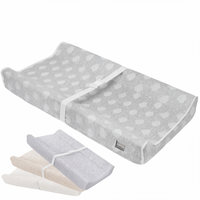 Gray contoured baby changing pad with white cloud pattern cover