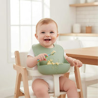 toddler wearing silicone bib during feeding time to keep clothes clean
