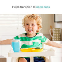 toddler using training sippy cup helping transition from bottle to open cup