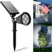 Solar spotlights providing bright LED lighting for a garden flagpole.