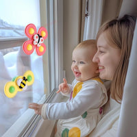 spinning top baby toy with suction base for interactive play
