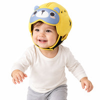 Toddler wearing protective cap while practicing first steps