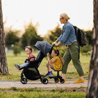 Toddler ride on stroller platform designed for standing behind a compatible stroller