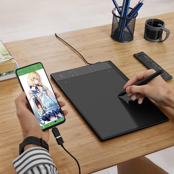 User drawing on  tablet connected to laptop