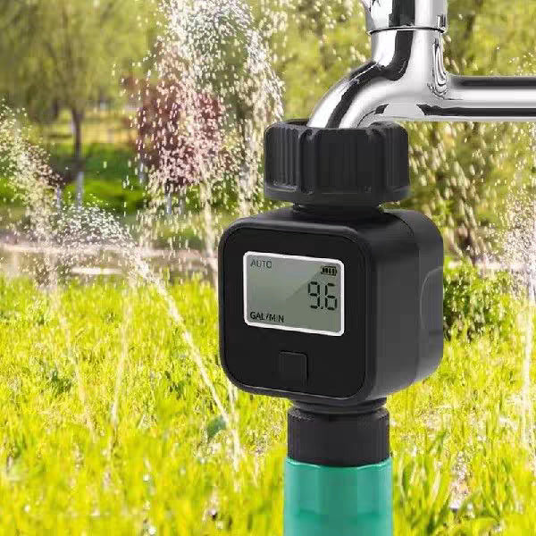 Brass water flow meter attached to a garden hose for measuring flow rate and water consumption
