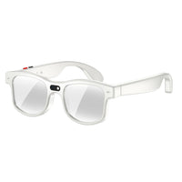 Adult wearing black smart eyewear during a casual walk outdoors.