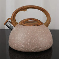 Stovetop kettle with covered whistling spout and removable lid