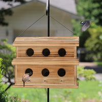 Front view of a wooden bird house with six openings