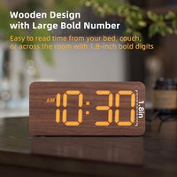 Wooden digital alarm clock placed on bedroom bedside desk
