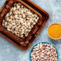 Wooden snack bowl with built-in compartment for empty nut shells