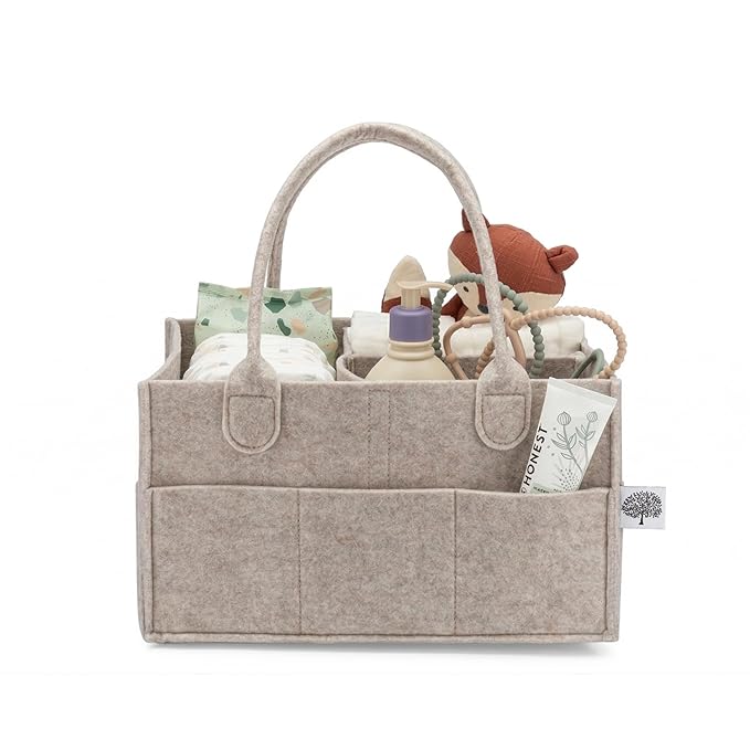 Neutral grey woven cotton rope diaper caddy with white accents on a nursery table